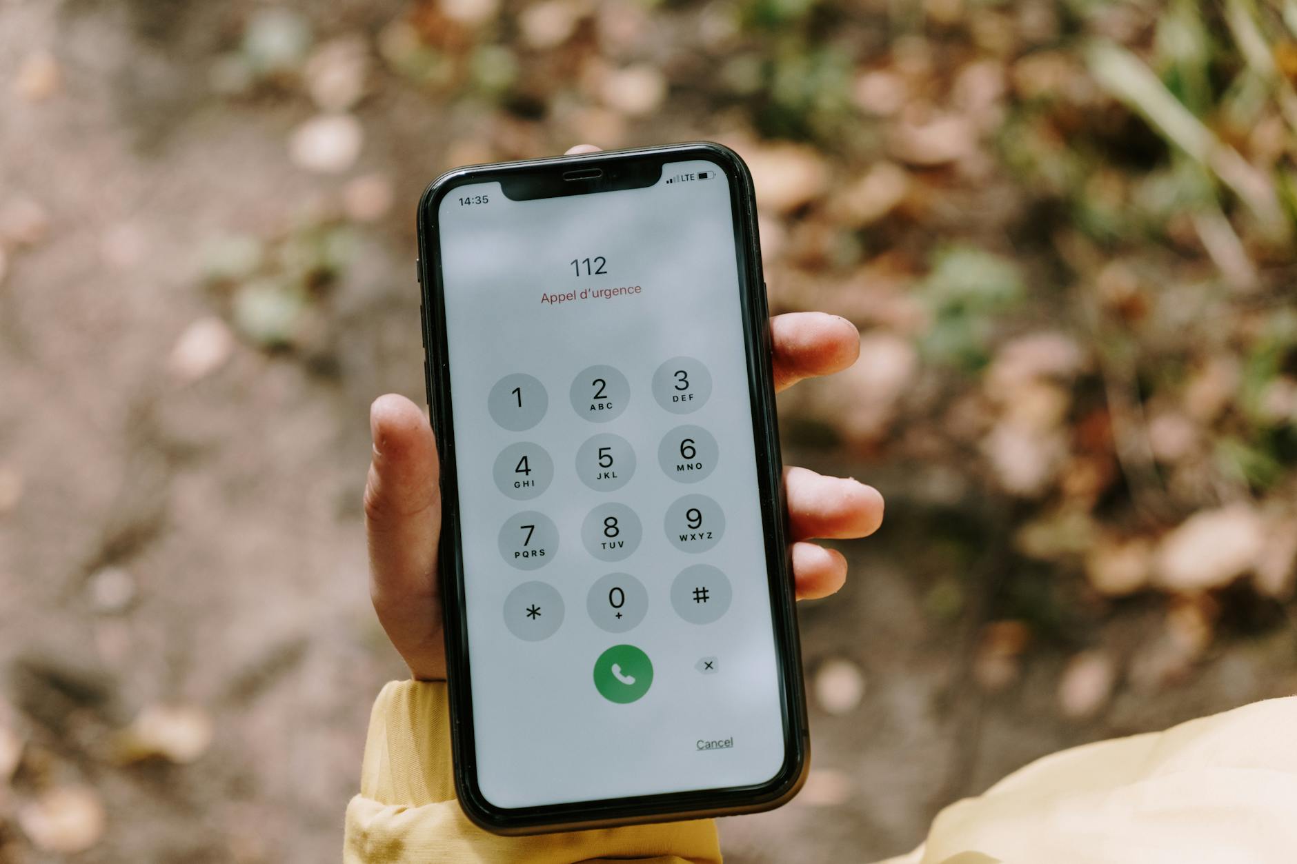 Smartfon na zewnątrz z wybranym numerem alarmowym